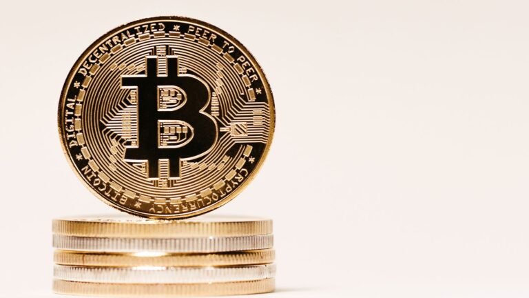 Close-up of gold Bitcoin cryptocurrency coins on a neutral background, representing Ethereum and the broader crypto market this week