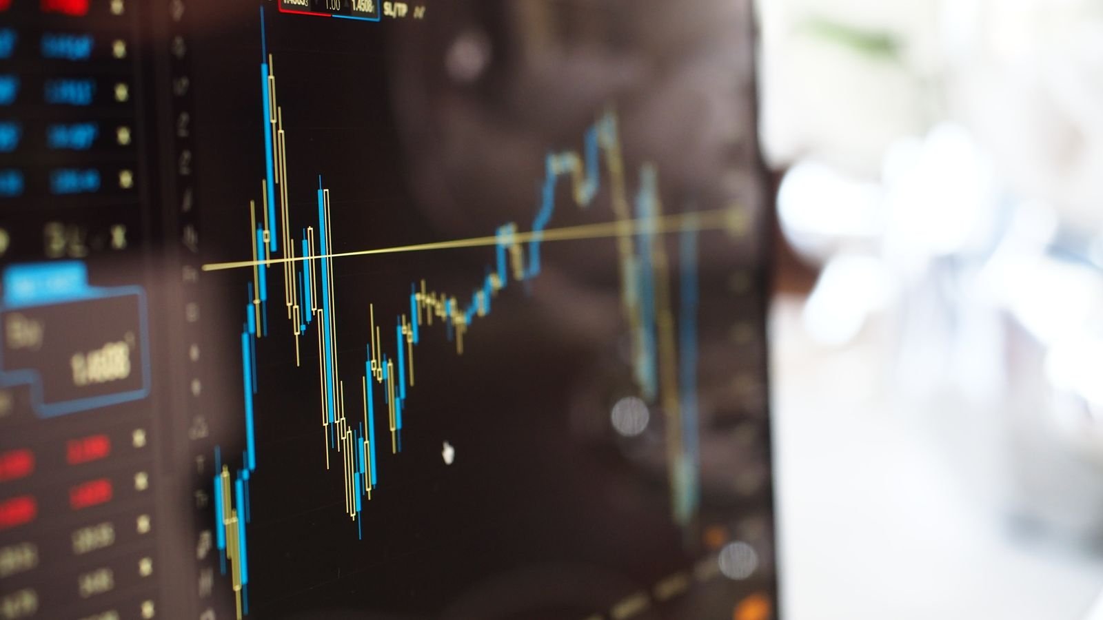 Close-up of a digital screen showing financial trading graphs, representing surging Treasury yields hitting a multi-decade high