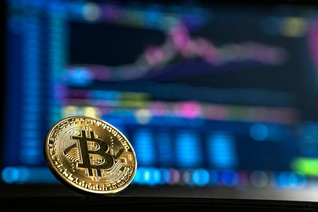 Gold-colored bitcoin coin representing direct bitcoin ownership versus a bitcoin ETF