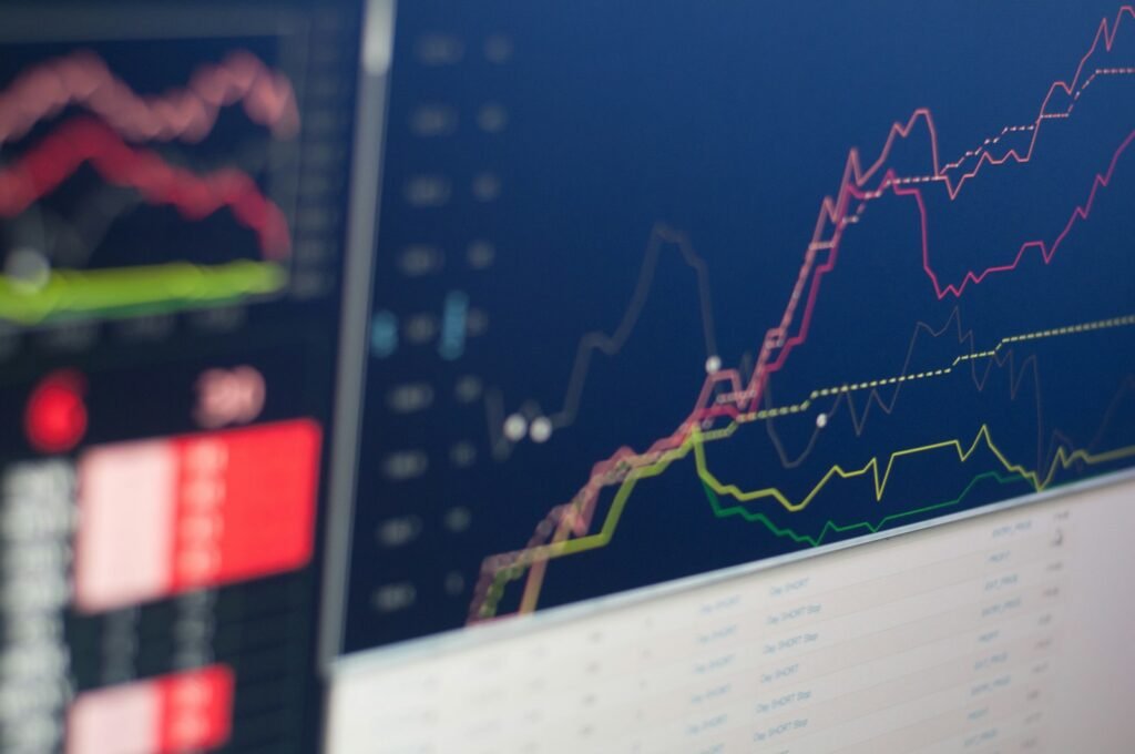 Close-up of a monitor displaying stock charts during a trading session